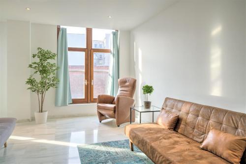 a living room with a couch and a chair at The Antwerp Marble Lodge in Antwerp
