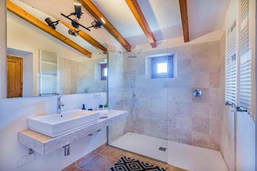 a bathroom with a sink and a shower at Villa Font Xica Petit by Sealand Villas in El Port