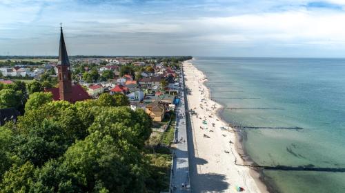 an aerial view of a beach and a church at Wczasowa 8 Apartments in Sarbinowo