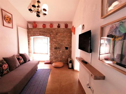 a living room with a couch and a tv at Casa do Alentejo in Elvas