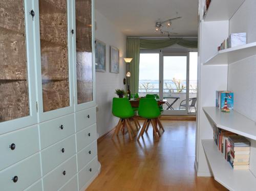 een woonkamer met groene stoelen en een tafel bij Villa Foerdestrand _ Spinnaker in Laboe