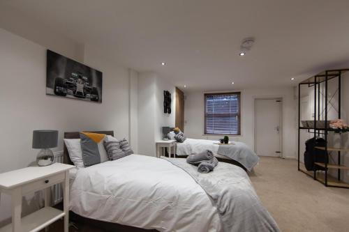 a bedroom with two beds with stuffed animals on them at Large House - Contractors & Families & Private Parking in Northampton