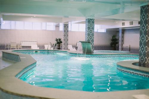 a large swimming pool in a hotel room at Sultan Plaza hotel in Qyzylorda