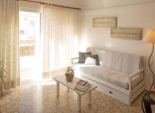 a living room with a bed and a table at Sa Barda - Formentera Break in Sant Ferran de Ses Roques