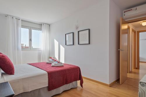 a bedroom with a bed and a table with a red blanket at Alcam Rubi in Rubí