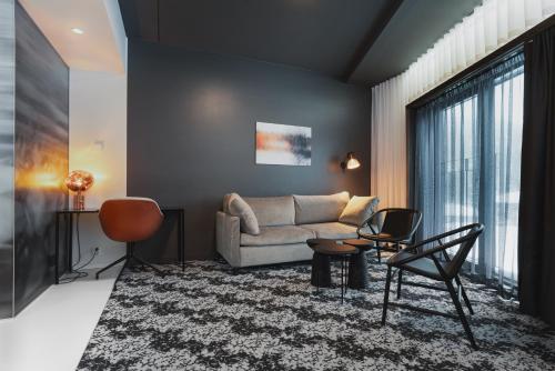 a living room with a couch and chairs at Design Hotel Levi in Levi
