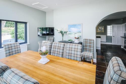 a living room with a table and chairs at Cherry Trees in Windermere
