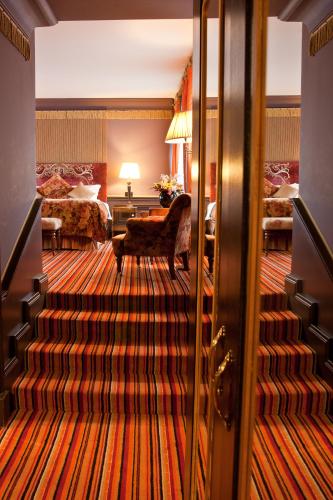a hotel room with a staircase leading to a bedroom at The Merchant Hotel in Belfast