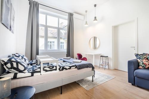 een woonkamer met een bed en een blauwe bank bij BpR Blooming Design Home with A/C in Boedapest