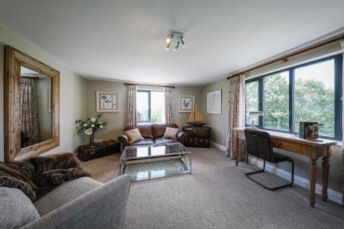 a living room with a couch and a table at Cherry Trees in Windermere