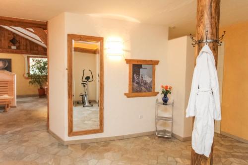a room with a white robe hanging on a wall at Reitanlage Dagnhof in Walchsee