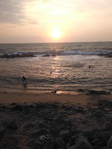 a person walking on the beach at sunset at VILLA ARIANNA in Wattala