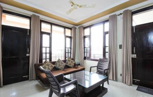 a living room with a couch and a table at Touristen Holiday Home A luxury Villa in Dharamshala