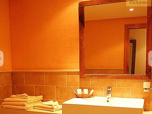 a bathroom with a sink and a mirror and towels at Sahara Douz in Douz