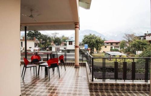 a table and chairs on a balcony with a view at Touristen Holiday Home A luxury Villa in Dharamshala