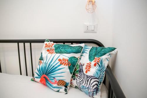 a bed with two pillows on top of it at AllYouCanTrip - La Nova in Naples