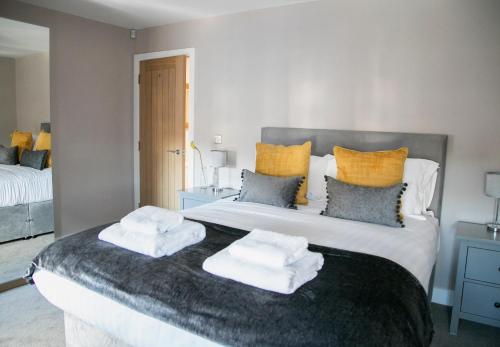 a bedroom with a large bed with towels on it at Alpha Spa classic 1 bedroom apartment in Harrogate