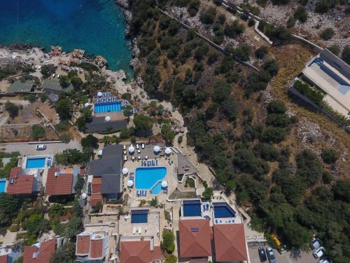 an aerial view of a house with a swimming pool at Kulube Hotel in Kalkan