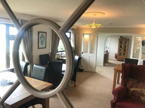 a mirror in a living room with a table and chairs at Wellingtons in Fowey