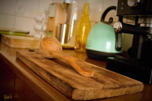 a wooden spoon sitting on top of a wooden cutting board at The balcony of Meteora the center of kalabaka in Kalabaka