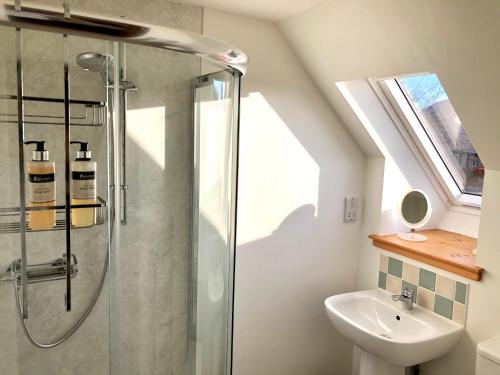 a bathroom with a shower and a sink at Albatross B&B Dornoch in Dornoch