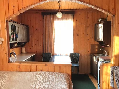 a room with a kitchen and a bed in a room at Дом для отдыха близко Батуми in Batumi