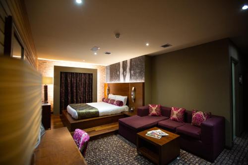 a hotel room with a couch and a bed at The Crown Hotel Bawtry-Doncaster in Bawtry