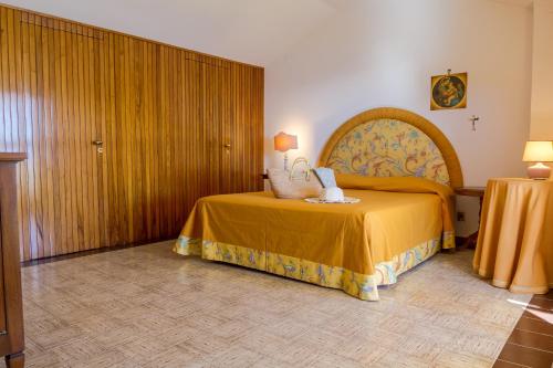a bedroom with a bed with a large headboard at La Plage - Home and Sea in Nizza di Sicilia