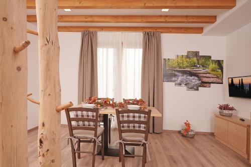 a dining room with a table and two chairs at Agriturismo Hegemone in Tremosine Sul Garda