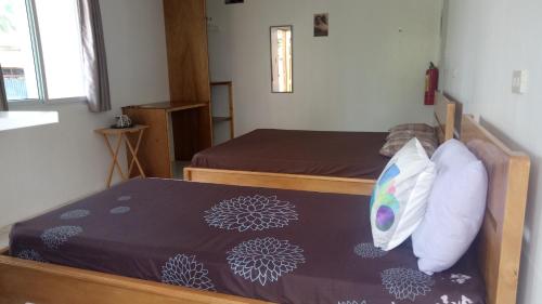 a bedroom with two beds in a room at Kathleens Vacation Place in Moalboal