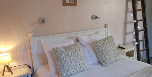 a bedroom with a white bed with two pillows at Hôtel Terminus in Luz-Saint-Sauveur