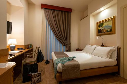 Ένα ή περισσότερα κρεβάτια σε δωμάτιο στο Grand Hotel Europa & Restaurant
