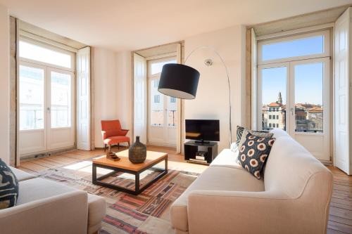 a living room with a couch and a table at Condes de Azevedo Palace Apartments in Porto