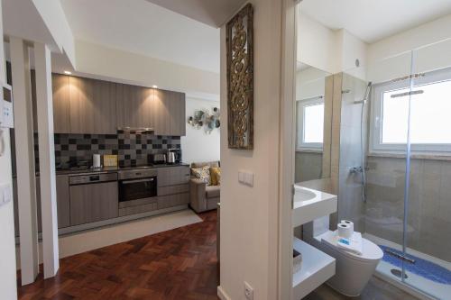 a bathroom with a shower and a sink and a toilet at Bairrus Lisbon Apartments - Duque in Lisbon