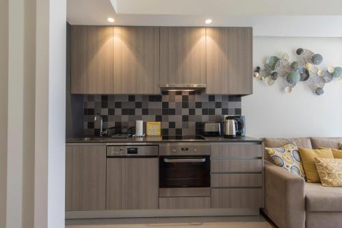 a kitchen with wooden cabinets and a stove and a couch at Bairrus Lisbon Apartments - Duque in Lisbon