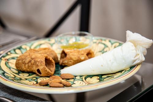 a plate with some food on a table at Brio Bed & Breakfast in Agrigento