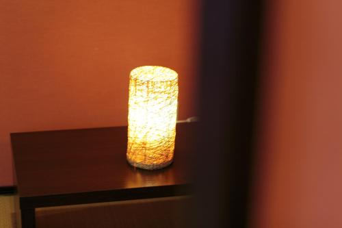 a glass vase sitting on top of a table at Guest House Ochakare in Kanazawa