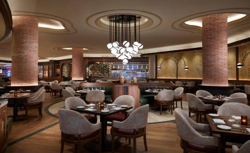 a restaurant with tables and chairs and a bar at The Guitar Hotel at Seminole Hard Rock Hotel & Casino in Fort Lauderdale