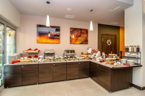 a buffet line in a restaurant with food at Hotel Emocja SPA in Mielno