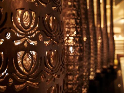a close up of a metal wall with lights at Pullman Hanoi in Hanoi
