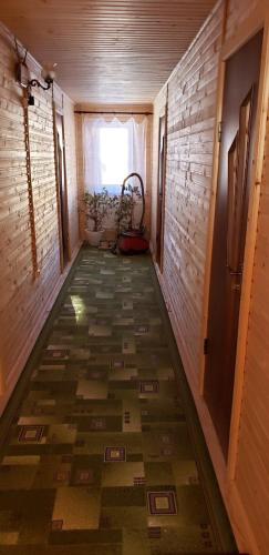 a hallway of a room with a floor with a window at Marichka in Yablunytsya