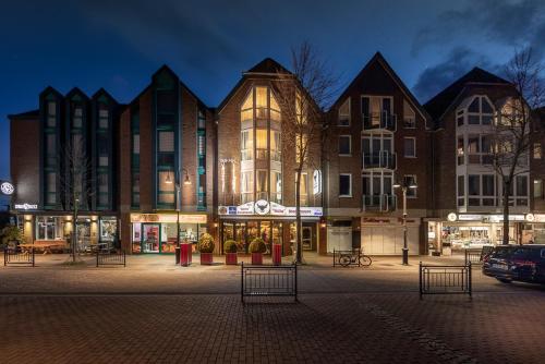 a large building in front of a street at night at Hotel Allegra in Heinsberg