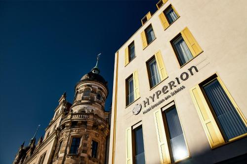 
a large building with a clock on the front of it at Hyperion Hotel Dresden Am Schloss in Dresden

