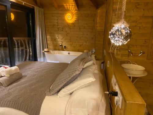 a bedroom with a bed and a tub and a sink at Les Suites in Santa María de Palautordera
