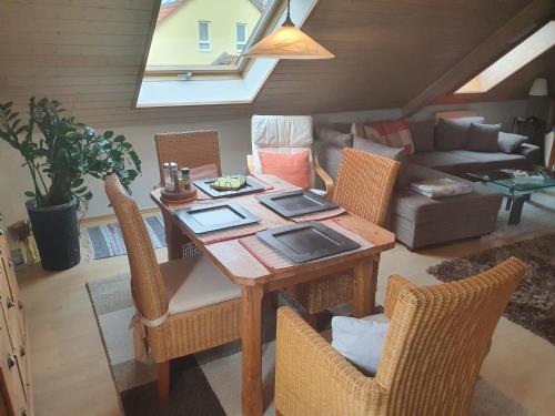 a living room with a wooden table and chairs at Just like home in Erding