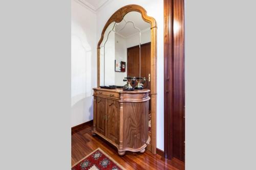 a bathroom with a wooden vanity and a large mirror at APARTAMENTO EN A ESTRADA/GALICIA in A Estrada