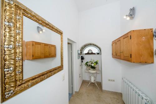 a mirror hanging on a wall in a hallway at Apartment Starčević in Kampor