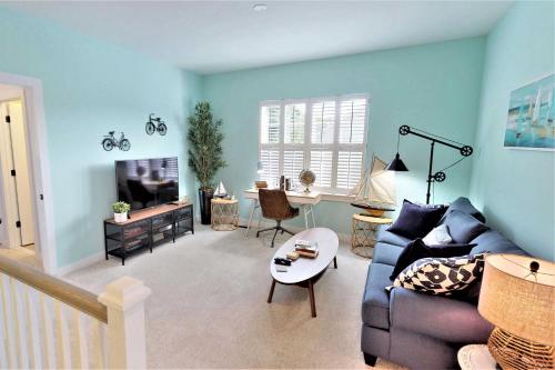 a blue living room with a couch and a table at 2 Mi to Bethany Beach Family-Friendly Home! in Ocean View