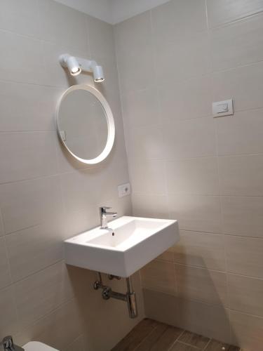 a bathroom with a sink and a mirror on the wall at Pause Lake Garda in San Giorgio