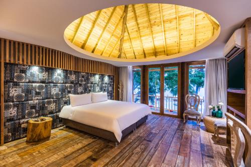 1 dormitorio con 1 cama y techo grande en Hotel Isla del Encanto, en Barú